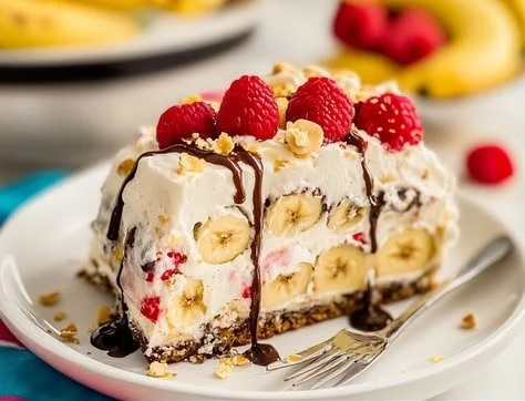 Delicious Banana Split Cake layered with bananas, whipped cream, and chocolate sauce