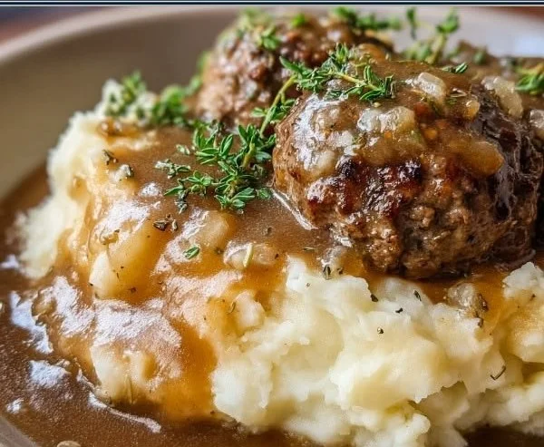 Delicious beef and gravy served over creamy mashed potatoes