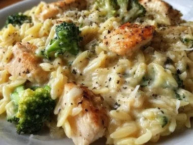 Creamy cheesy chicken broccoli orzo dish served in a bowl