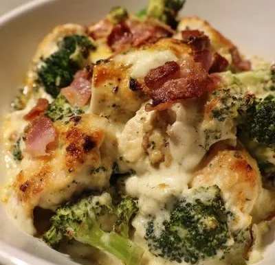 Creamy low carb chicken casserole with broccoli and bacon served in a dish.