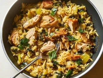 Creamy one-pot tuna orzo with zucchini served in a bowl.