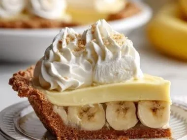 Delicious homemade banana cream pie slice with fresh bananas and whipped cream