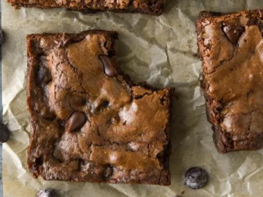 Decadent easy chocolate brownies on a wooden table, ready to enjoy.