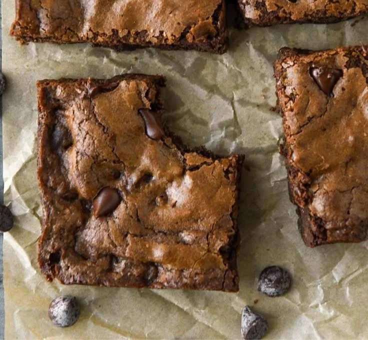 Decadent easy chocolate brownies on a wooden table, ready to enjoy.