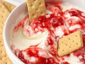 Delicious easy strawberry cheesecake dip served with fresh strawberries and graham crackers