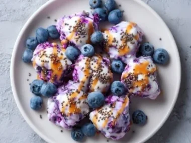 Healthy frozen blueberry yogurt clusters topped with fresh berries.