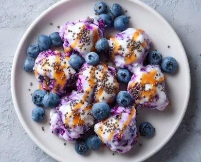 Healthy frozen blueberry yogurt clusters topped with fresh berries.