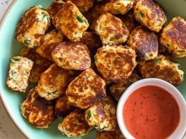 Plate of healthy veggie ricotta fritters garnished with herbs.
