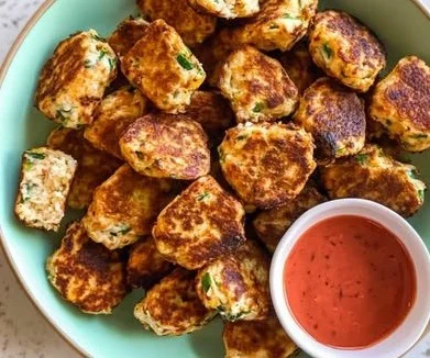 Plate of healthy veggie ricotta fritters garnished with herbs.