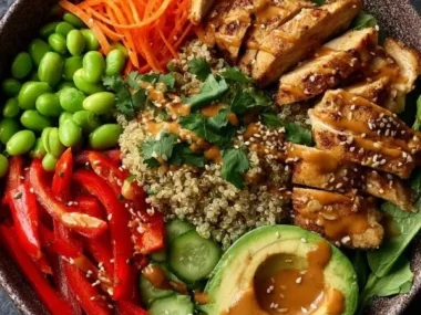 High Protein Thai Peanut Chicken Buddha Bowl with fresh veggies and peanut sauce