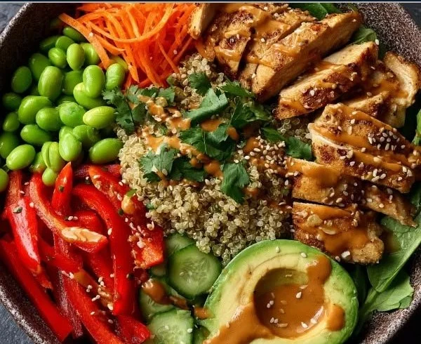 High Protein Thai Peanut Chicken Buddha Bowl with fresh veggies and peanut sauce
