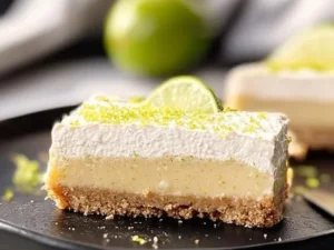 Delicious key lime pie bars topped with whipped cream and lime zest