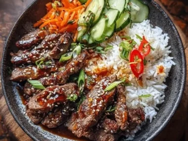 Korean BBQ Steak Bowl topped with fresh vegetables and sauces