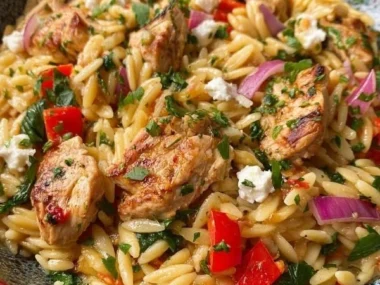 Delicious Mediterranean Chicken Orzo served with fresh herbs and vegetables.