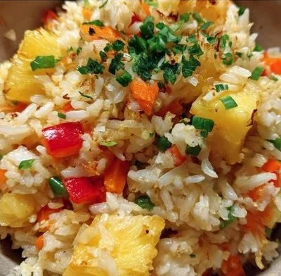 Deliciously prepared Pineapple Rice topped with vibrant vegetables and herbs