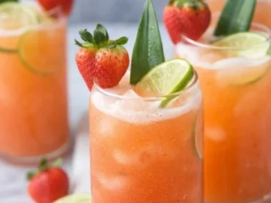 Pineapple Strawberry Water in a glass with fresh fruits