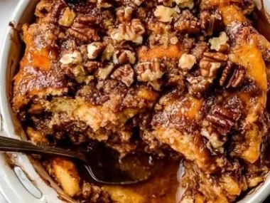 Delicious Pumpkin Spice French Toast Casserole topped with whipped cream and cinnamon.