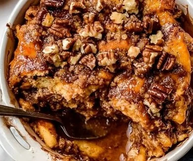 Delicious Pumpkin Spice French Toast Casserole topped with whipped cream and cinnamon.