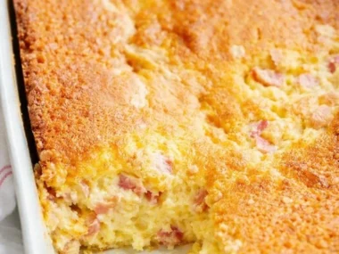 Delicious slice of Rhubarb Custard Cake with a golden crust and creamy filling.