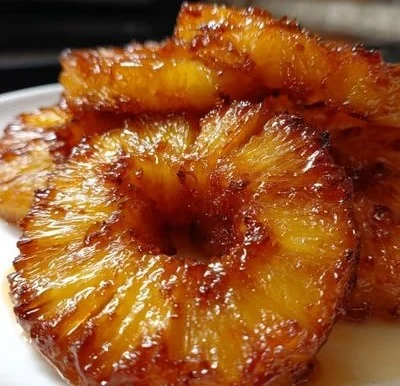 Delicious rum-soaked fried pineapple served as a tropical dessert treat