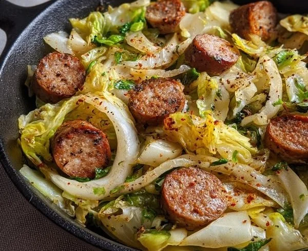 Sausage Cabbage Skillet meal served in a pan with fresh ingredients