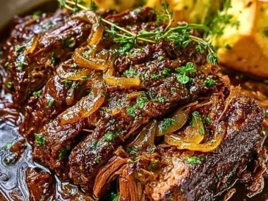 Slow Cooker French Onion Pot Roast served with onions and herbs