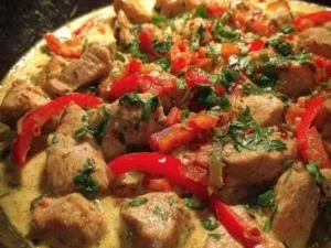 Delicious Spicy Brazilian Coconut Chicken garnished with fresh herbs