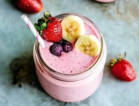 Delicious strawberry banana smoothie in a glass topped with fresh fruits