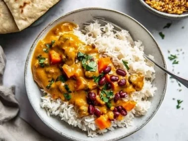 Delicious Vegan Lentil Pumpkin Curry served in a bowl with fresh herbs.