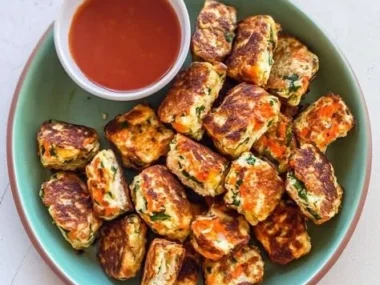 Deliciously crispy Vegetable Ricotta Fritters served with dipping sauce.